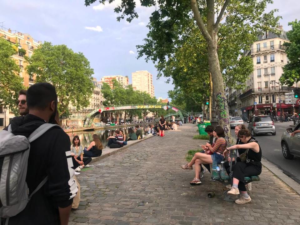 Parisions hang out along the Canal St. Martin in Paris, France. The canal connects the Canal de l’Ourcq to the river Seine. It’s a popular place for locals to hang out with friends, drink wine and eat snacks.