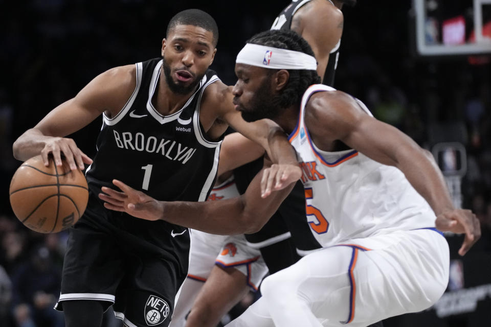 Brooklyn Nets forward Mikal Bridges (1) drives against New York Knicks forward Precious Achiuwa (5) during the second half of an NBA basketball game, Tuesday, Jan. 23, 2024, in New York. (AP Photo/Mary Altaffer)