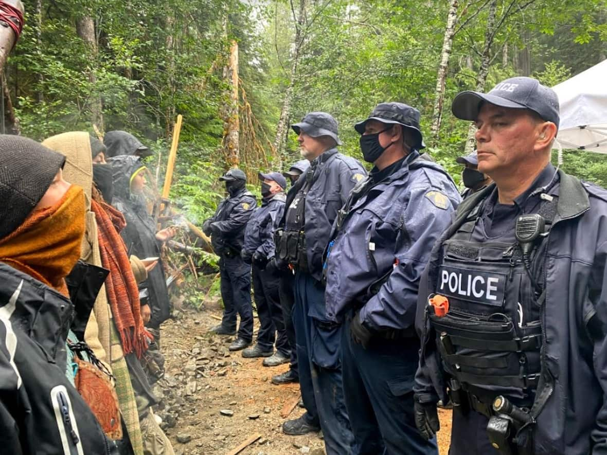 RCMP and old-growth logging demonstrators face off at the Fairy Creek blockades in 2021. An accounting shows the operation cost police nearly $19 million. (Adam van der Zwan/CBC - image credit)