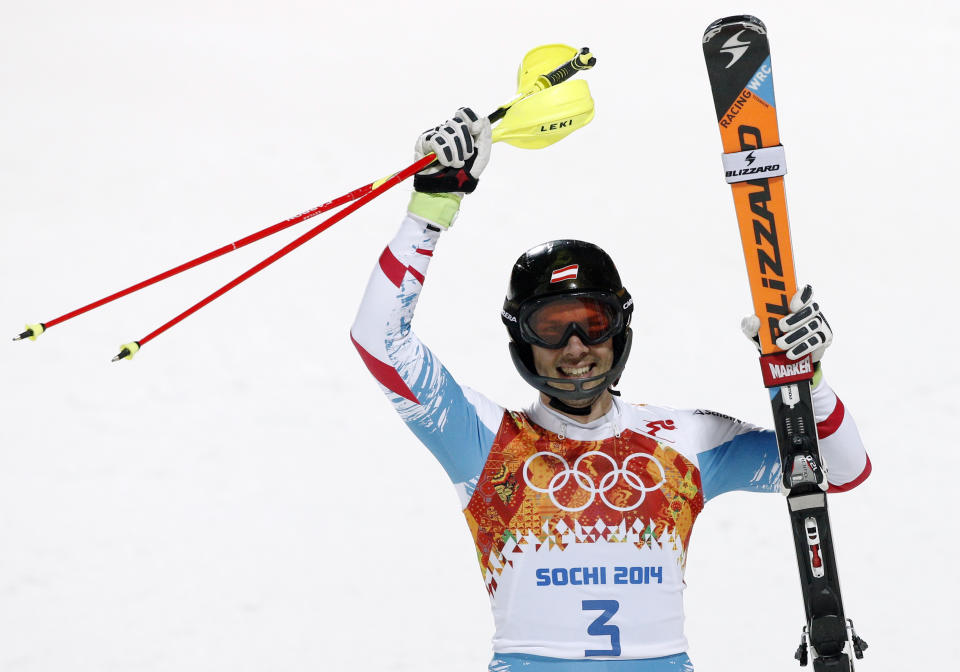 Austria's Mario Matt celebrates winning the gold medal in the men's slalom at the Sochi 2014 Winter Olympics, Saturday, Feb. 22, 2014, in Krasnaya Polyana, Russia. (AP Photo/Christophe Ena)