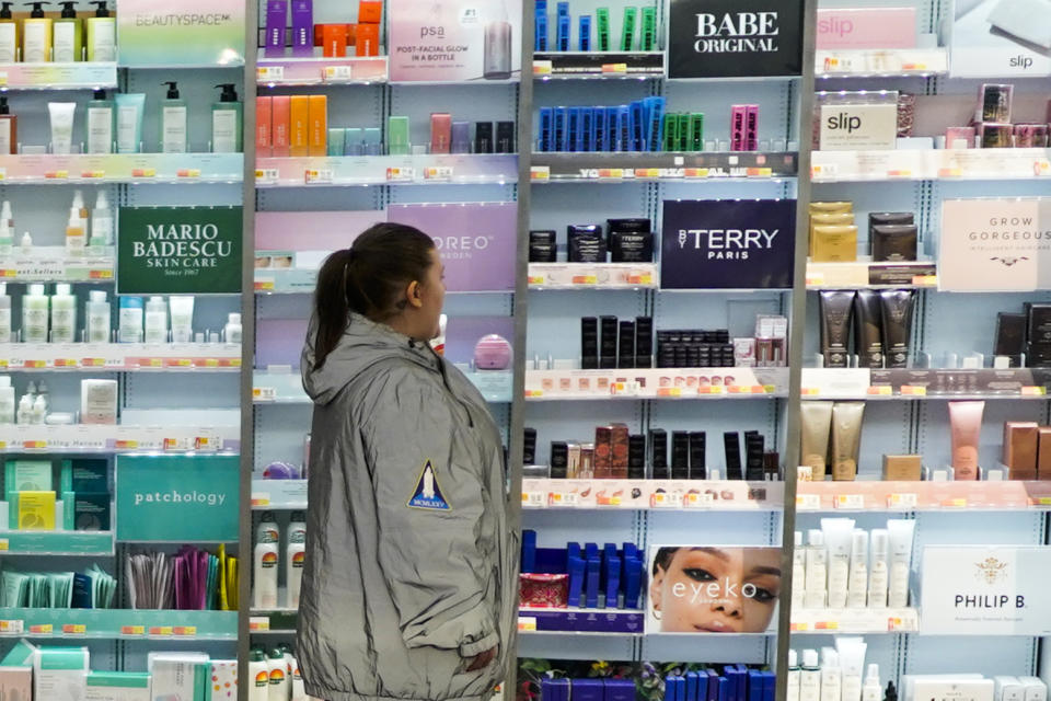 A woman passes by the BeautySpace NK display at the Walmart Supercenter in North Bergen, N.J., on Thursday, Feb. 9, 2023. Companies from toothpaste makers to even discounters are adding more premium items like designer body creams as they reach out to wealthier shoppers. Walmart features high-end $90 creams in its beauty aisles at select stores. (AP Photo/Eduardo Munoz Alvarez)