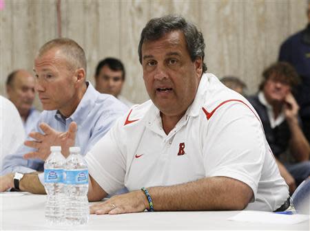 New Jersey Gov. Chris Christie talks to business owners affected by a massive fire that burned a large portion of the Seaside Park boardwalk in Seaside Heights, N.J. September 14, 2013. REUTERS/Julio Cortez/Pool