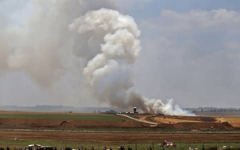 Smoke billows from the Israeli side after a kite loaded with a molotov cocktail crossed the border between Israel and the Gaza strip - Credit:  MOHAMMED ABED/AFP