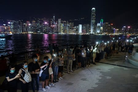 Protesters hold hands to form a human chain at the Avenue of Stars in Hong Kong