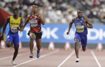 From right, Christian Coleman of the United States, Japan's Abdul Hakim Sani Brown and Barbados' Mario Burke compete during the men' 100 meters heats at the World Athletics Championships in Doha, Qatar, Friday, Sept. 27, 2019. (AP Photo/Petr David Josek)