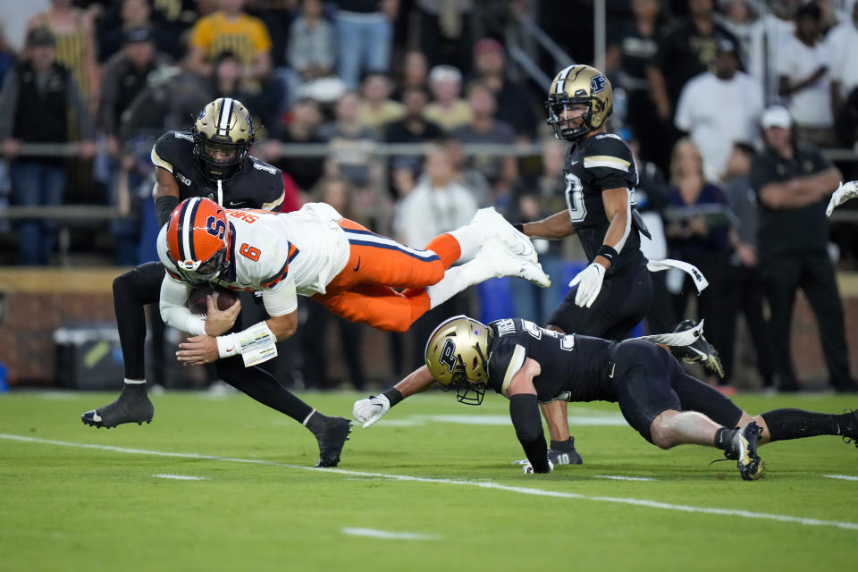 Syracuse quarterback Garrett Shrader is tackled Purdue defensive back Dillon Thieneman, lower right, during the first half of an NCAA college football game in West Lafayette, Ind., Saturday, Sept. 16, 2023. (AP Photo/AJ Mast)