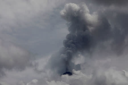 Smoke spews from the Fuego volcano, seen from San Miguel Los Lotes in Escuintla, Guatemala June 13, 2018. REUTERS/Carlos Jasso