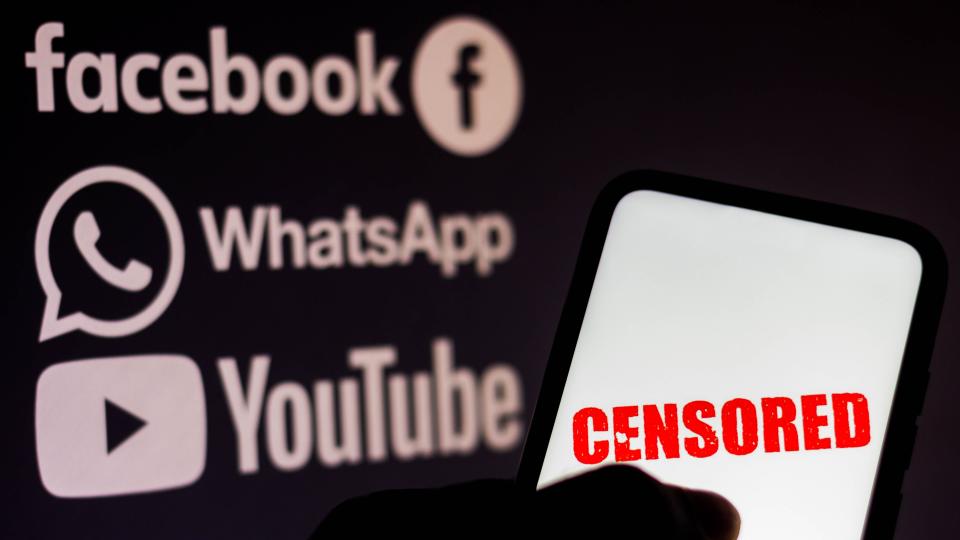  In this photo illustration the word censored is seen displayed on a smartphone with the logos of social networks Facebook, WhatsApp and YouTube in the background. 