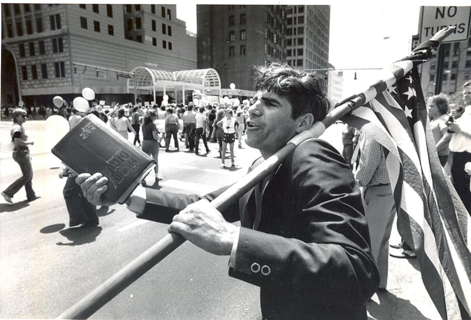 A member of the Pentecostal Holiness Church of Columbus, shown here, was among the fundamentalists who heckled several thousand gay activists marching in the city on June 24, 1984 for the Ohio-Michigan Lesbian and Gay Pride Parade. The marchers, however, drowned out the anti-gay demonstrators. Gay activist speakers said the gay community is gaining political clout. Close to 4,000 marchers left Goodale Park about 2 p.m. to march to the Ohio Statehouse.