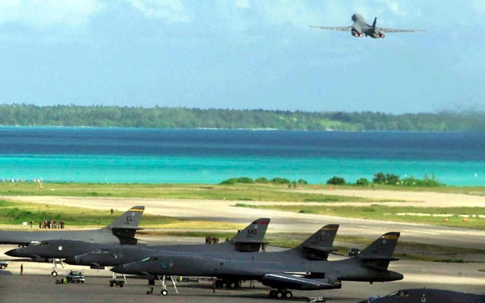 A plane takes off while others stand on a runway