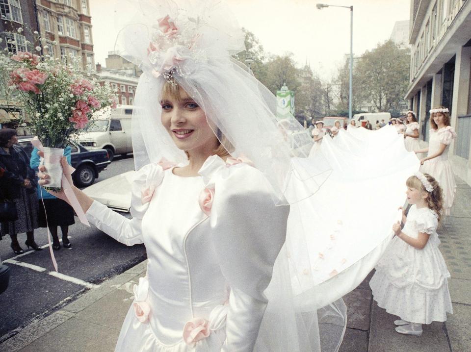 A model wearing a 50 foot-long wedding dress which designers hoped to get into the Guinness Book of Records as the world’s longest in 1987.