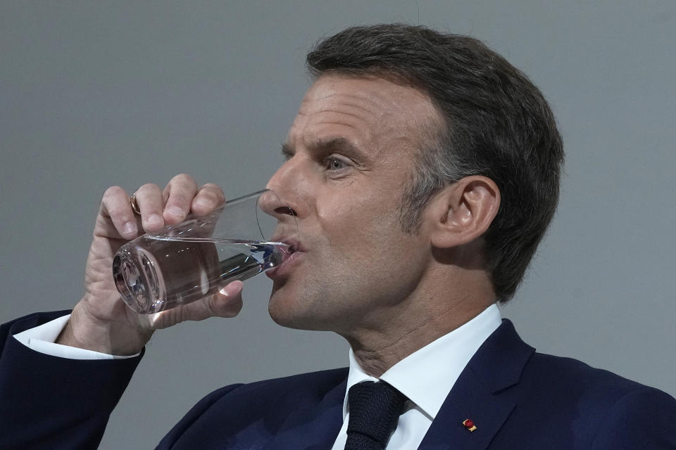 French President Emmanuel Macron drinks as he delivers a speech, Wednesday, June 12, 2024 in Paris. President Emmanuel Macron is addressing French voters on Wednesday for the first times since he has called snap national election following a crushing defeat of his party by the far-right in the European vote. (AP Photo/Michel Euler)