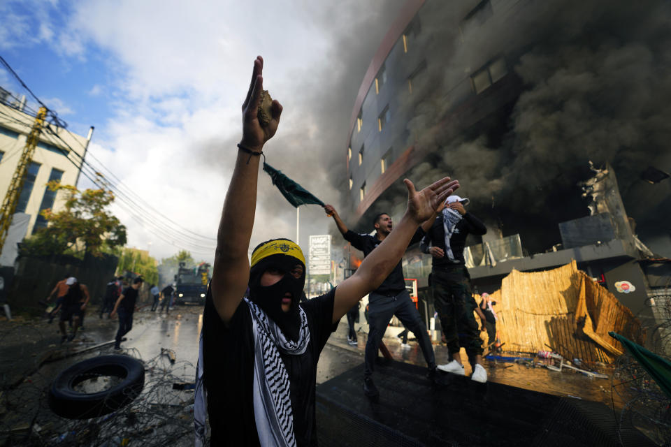 Protesters chant slogans during a demonstration in solidarity with the Palestinian people in Gaza, near the U.S. embassy in Aukar, a northern suburb of Beirut, Lebanon, Wednesday, Oct. 18, 2023. (AP Photo/Hassan Ammar)