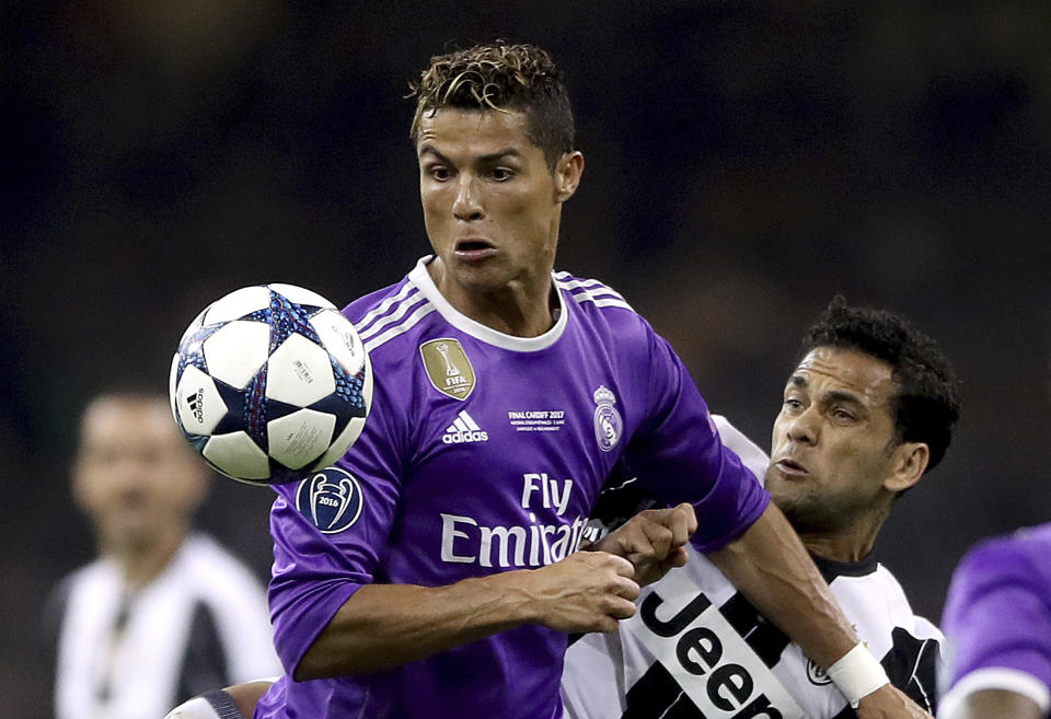 <p>Real Madrid’s Cristiano Ronaldo, left, and Juventus’ Dani Alves battle for the ball during the Champions League Final soccer match between Juventus and Real Madrid at the Millennium Stadium in Cardiff, Wales, Saturday, June 3, 2017. (Nick Potts/PA via AP) </p>