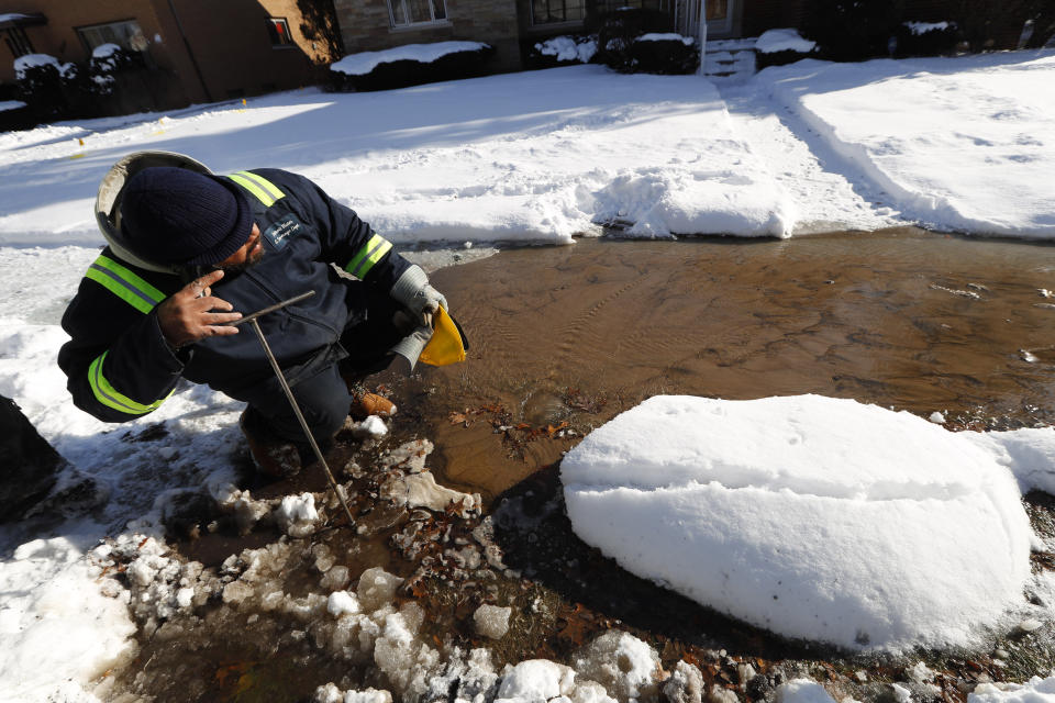 Chuck Bryant, a Detroit Water and Sewerage worker, uses an aqua phone to locate a water main break in Detroit, Wednesday, Jan. 30, 2019. A deadly arctic deep freeze enveloped the Midwest with record-breaking temperatures on Wednesday, triggering widespread closures of schools and businesses. (AP Photo/Paul Sancya)