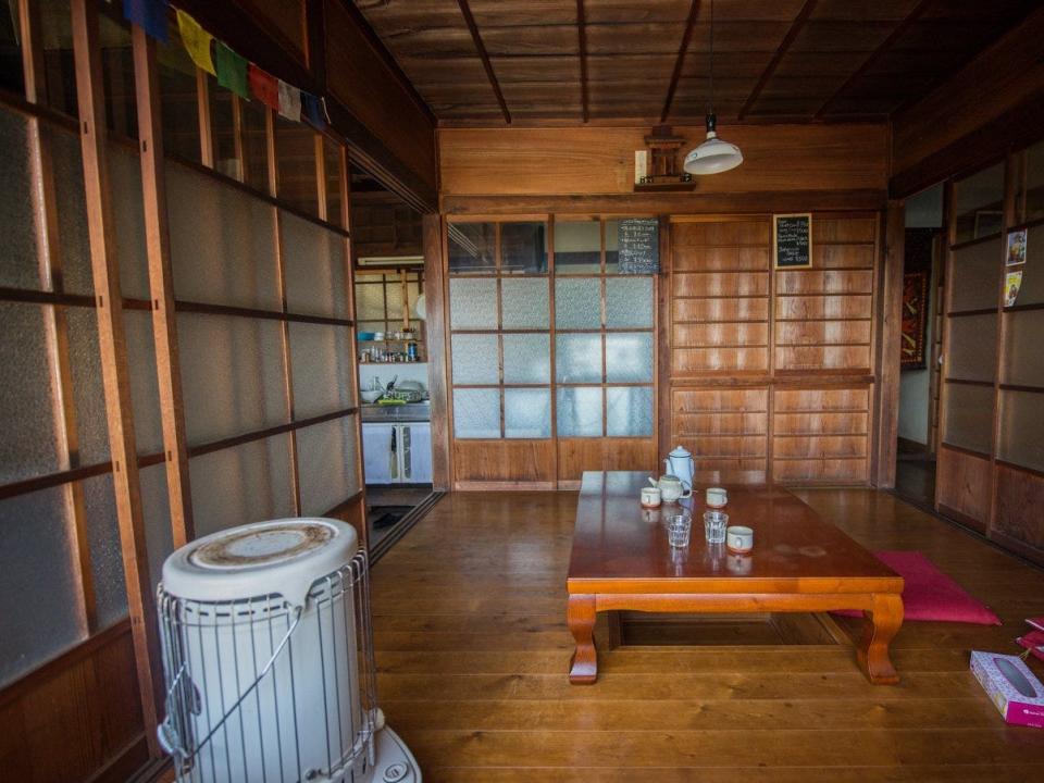 The interior of the akiya shows wood paneling and a clean, minimal design