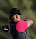 Northern Ireland's Rory McIlroy plays a shot during the first round of the Abu Dhabi Golf Championship at the Abu Dhabi Golf Club in the Emirati capital on January 17, 2013. Justin Rose grabbed a share of the first round lead in the Abu Dhabi Golf Championship on a day when both McIlroy and Tiger Woods struggled to get their seasons into gear