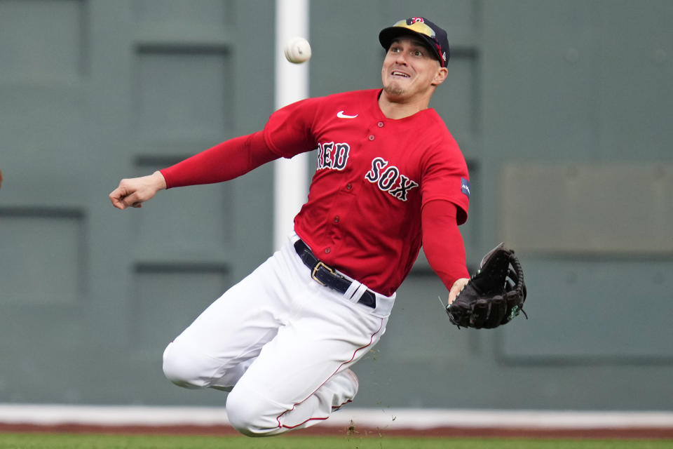 Boston Red Sox center fielder Enrique Hernandez makes the play on a flyout by Tampa Bay Rays' Luke Raley during the sixth inning of a baseball game at Fenway Park, Monday, June 5, 2023, in Boston. (AP Photo/Charles Krupa)