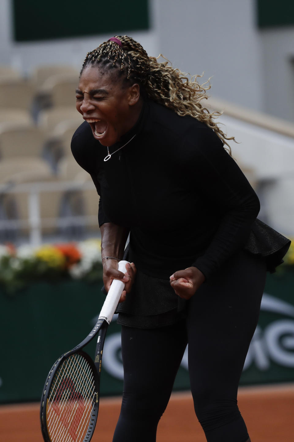 Serena Williams of the U.S. screams in the first round match of the French Open tennis tournament against Kristie Ahn of the U.S. at the Roland Garros stadium in Paris, France, Monday, Sept. 28, 2020. (AP Photo/Alessandra Tarantino)