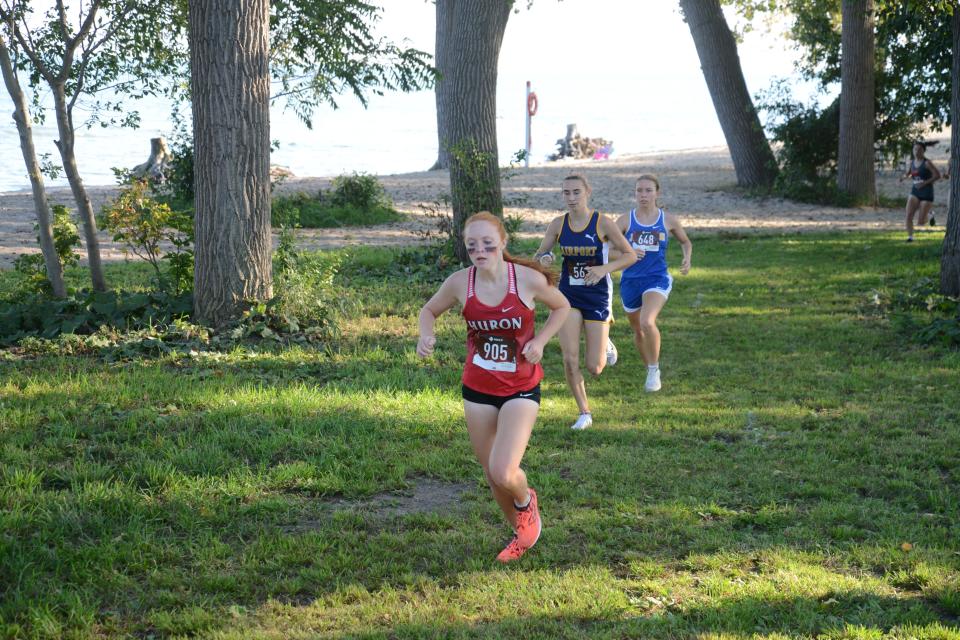 Avery Turk of New Boston Huron, Cecilia Ortega of Airport and eventual winner Jenna Pilachowski of Jefferson surge to the front of the pack during the early stages of the Huron League cross country jamboree at Sterling State Park Tuesday.