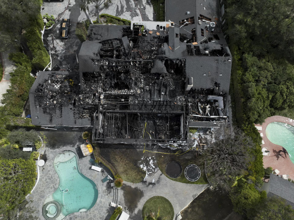 An aerial view shows a fire-damaged property, which appears to belong to Cara Delevingne, Friday, March 15, 2024, in the Studio City section of Los Angeles. (AP Photo/Jae C. Hong)