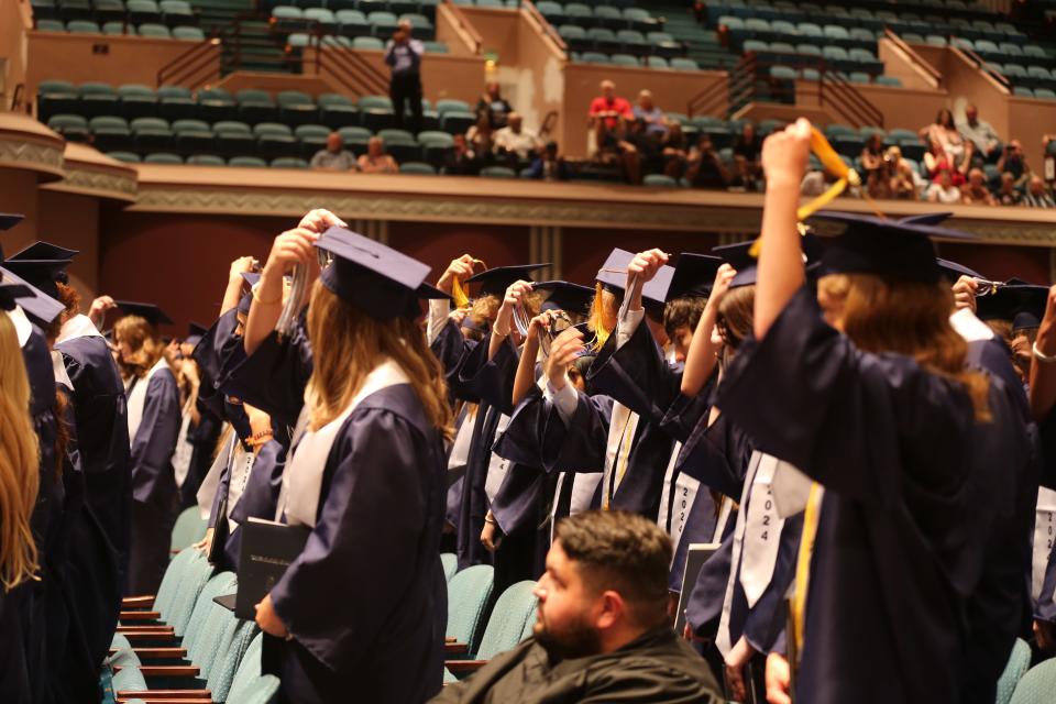 Kansas is updating the minimum graduation requirements for students of public and accredited private high schools, like these Hayden Catholic High School seniors who graduated on Saturday.