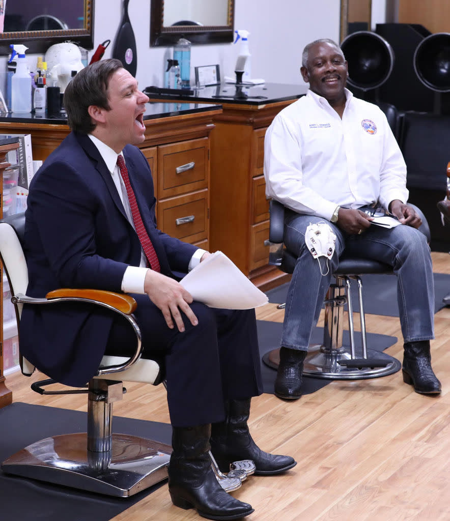 Ron DeSantis laughing in a barbershop