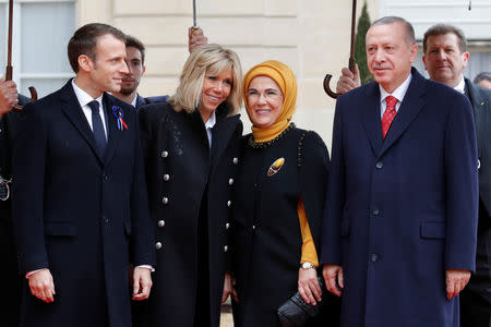 French President Emmanuel Macron and his wife Brigitte Macron welcome Turkey's President Tayyip Erdogan with his wife Emine Erdogan at the Elysee Palace as part of the commemoration ceremony for Armistice Day, 100 years after the end of the First World War, in Paris, France, November 11, 2018. REUTERS/Philippe Wojazer