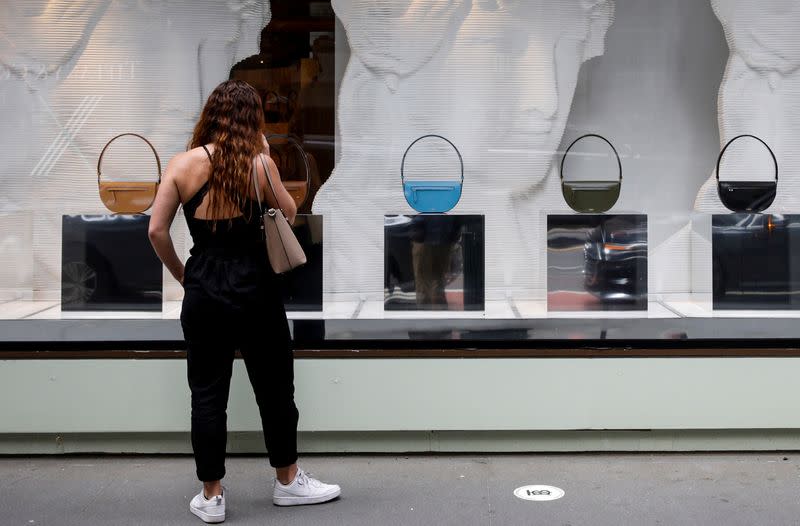 A shopper looks at handbags at Burberry on 5th Avenue in New York