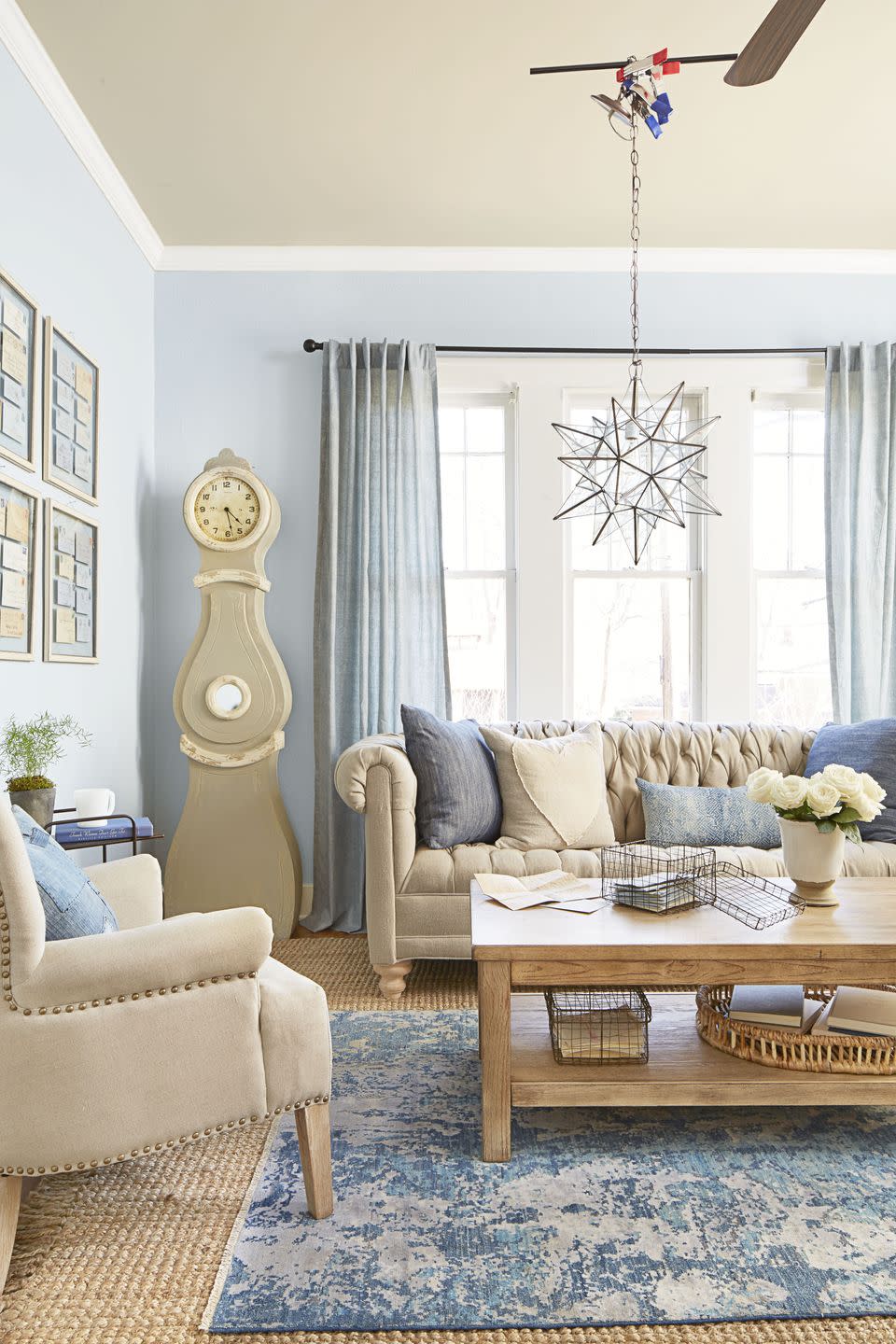 living room with light blue walls and light gray furnishings