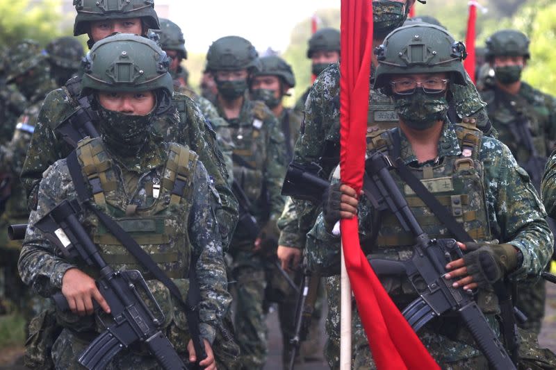 FILE PHOTO: Soldiers march to position during an anti-invasion drill on the beach during the annual Han Kuang military drill in Tainan