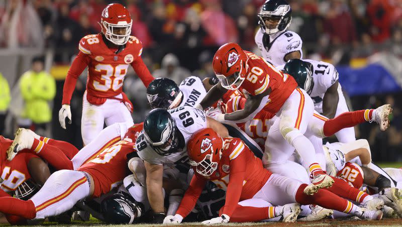 Philadelphia Eagles quarterback Jalen Hurts (1), at bottom of pile, gains a first down on a “Tush Push” against the Kansas City Chiefs during a game on Nov. 20, 2023 in Kansas City, Mo.