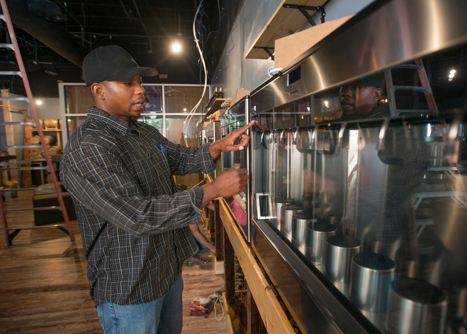 Co-owner John McCorvey demonstrates the wine dispencing system at the new Casks & Flights wine tasting & tap room on Palafox Place in downtown Pensacola on Tuesday, June 12, 2018.  Casks & Flights is scheduled to be opened in July.