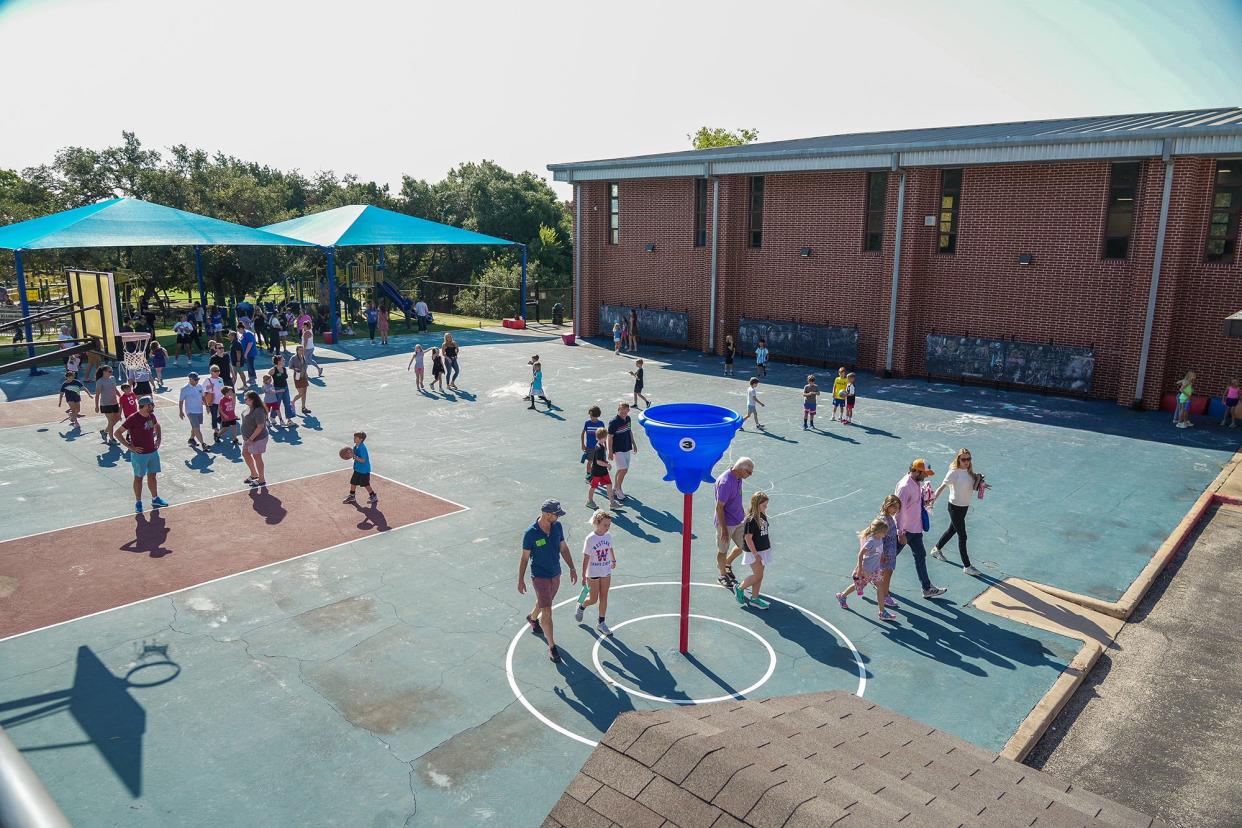 Students play outside the Eanes school district's Valley View Elementary School in 2023. The Eanes district pressed a school board candidate to stop using the district's official logo in his campaign materials.