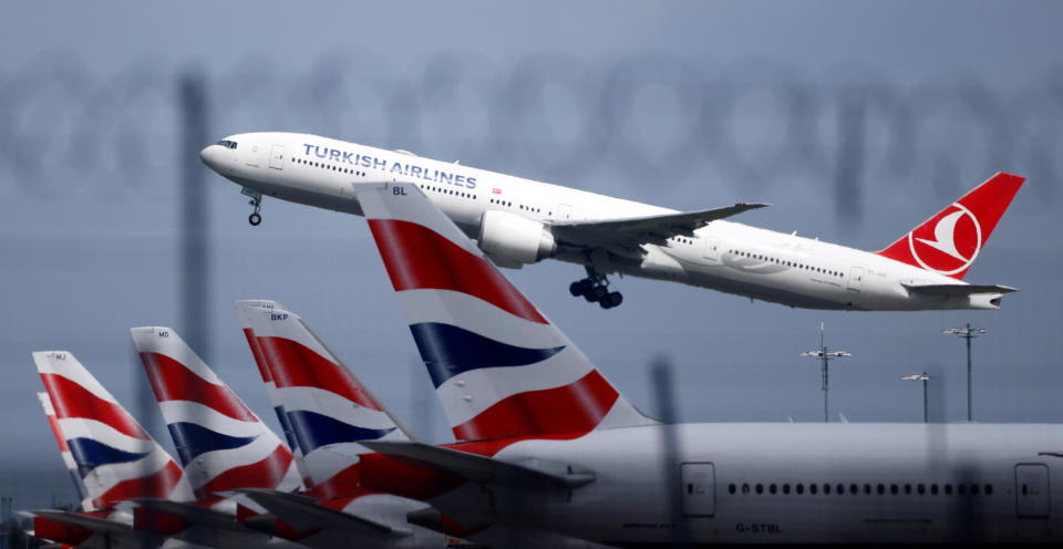 BA  strike Turkish Airlines Boeing 777 takes off past parked British Airways aircraft at Heathrow Airport in London, Britain, May 17, 2021. REUTERS/John Sibley
