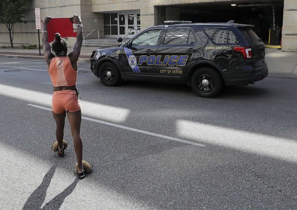 PHOTO: A protestor yells at a Police officer as he drives by the front of the Akron City Justice Center in Akron, Ohio, July 2, 2022. (Aaron Josefczyk/UPI/Shutterstock)