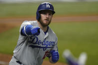 Los Angeles Dodgers first baseman Max Muncy celebrates a home run against the Tampa Bay Rays during the fifth inning in Game 5 of the baseball World Series Sunday, Oct. 25, 2020, in Arlington, Texas. (AP Photo/Eric Gay)