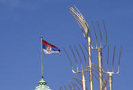 A Serbian flag waves on the Serbian Parliament building during a protest in front of the Serbian Parliament building in Belgrade, Serbia, Saturday, April 10, 2021. Environmental activists are protesting against worsening environmental situation in Serbia. (AP Photo/Darko Vojinovic)