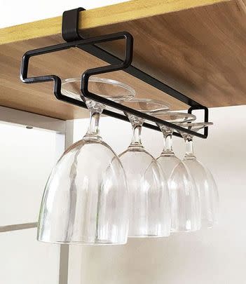 Hang stemmed glasses from an under-shelf rack