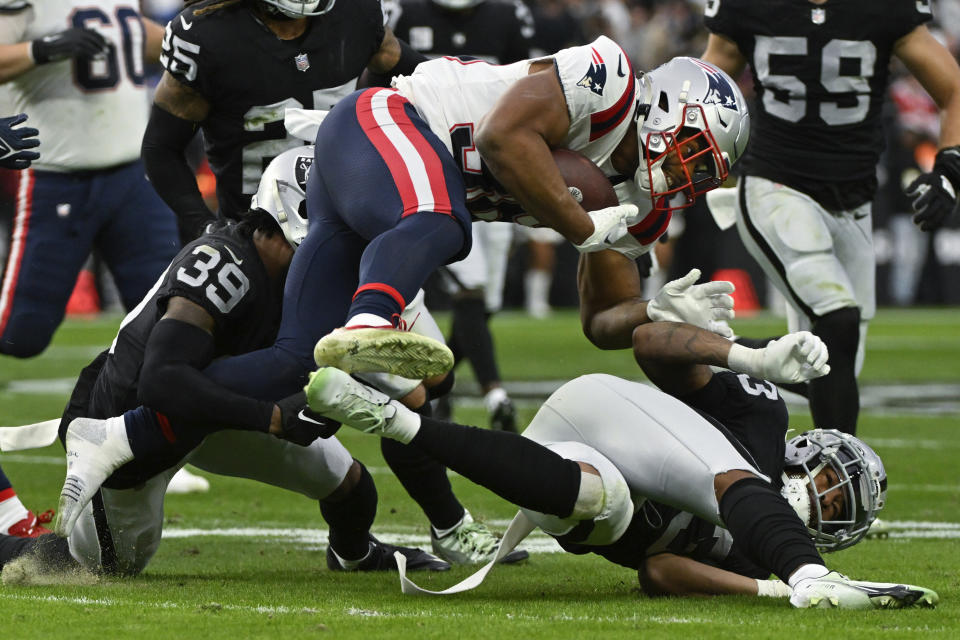 New England Patriots running back Kevin Harris (36) is tackled by Las Vegas Raiders cornerback Nate Hobbs (39) during the first half of an NFL football game between the New England Patriots and Las Vegas Raiders, Sunday, Dec. 18, 2022, in Las Vegas. (AP Photo/David Becker)