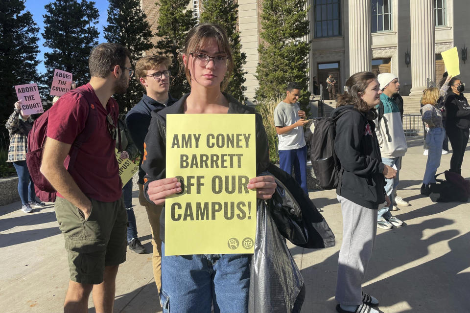 Anita Goncharuk, a first-year student majoring in biomedical engineering at the University of Minnesota, holds a sign that reads at a protest, Monday, Oct. 16, 2023, outside the Cyrus Northrop Memorial Auditorium in Minneapolis. (AP Photo/Trisha Ahmed)