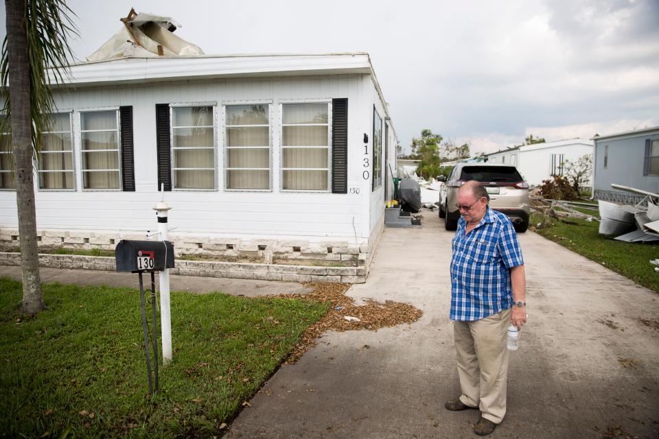 In this file photo, Ed Pearson, 78, stands outside his home in Naples Estates, a mobile home community in Naples, Florida, shortly after shaking President Donald Trump's hand during a brief visit Thursday, September 14, 2017. Pearson's home of 17 years flooded and had the roof ripped off due to Hurricane Irma.