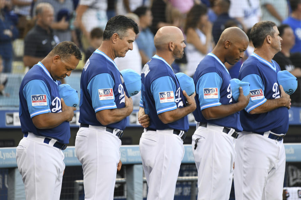 <p>Los Angeles Dodgers coaching staff stand for a moment of silence for deceased Senator John McCain before a baseball game against the San Diego Padres, Saturday, Aug. 25, 2018, in Los Angeles. (Photo: Michael Owen Baker/AP) </p>