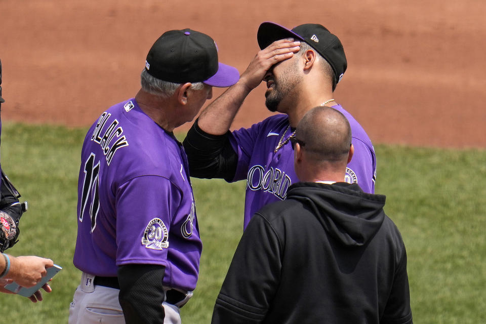 Colorado Rockies starting pitcher Antonio Senzatela, right rear, is visited on the mound by manager Bud Black (10) and a team trainer after giving up a two-run home run to Pittsburgh Pirates' Andrew McCutchen during the third inning of a baseball game in Pittsburgh, Wednesday, May 10, 2023. Black made a call to the bullpen and Senzatela left the game with the trainer. (AP Photo/Gene J. Puskar)