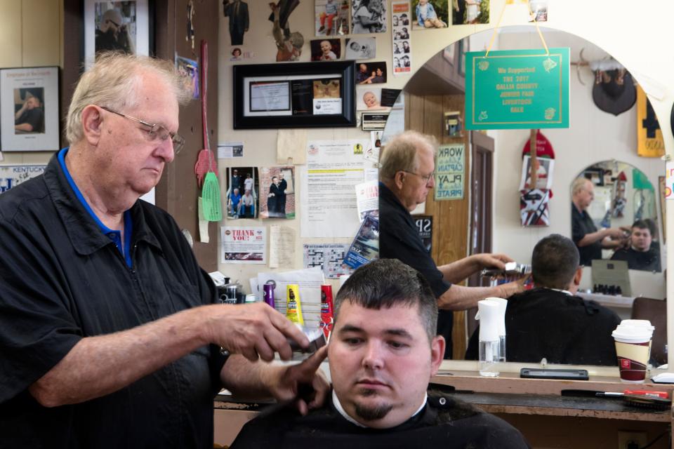 Josh Skidmore has his hair cut by Herald Montgomery, County Commissioner, at Montgomery Barber Shop in Gallipolis, Ohio, on Thursday, Sept. 12, 2019. Montgomery is a republican County Commissioner who supports Donald Trump. 