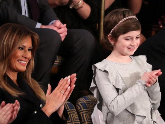 First lady Melania Trump applauds with cancer survivor Grace Eline as she is mentioned by US president Donald Trump in his second State of the Union address (Jonathan Ernst/Reuters)