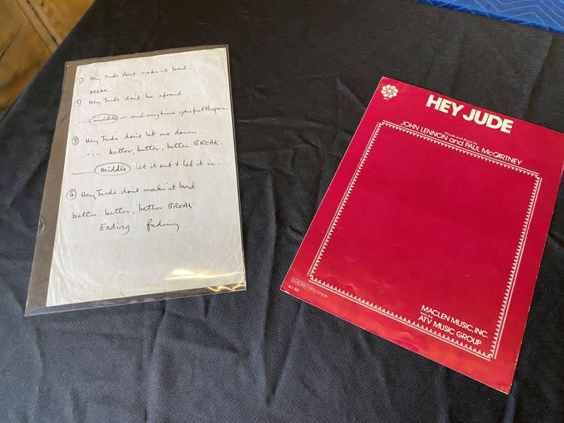 A sheet of paper with partial "Hey Jude" lyrics, written by Paul McCartney for a recording session in 1968, is displayed in a Julien's Auctions warehouse in Torrence, California