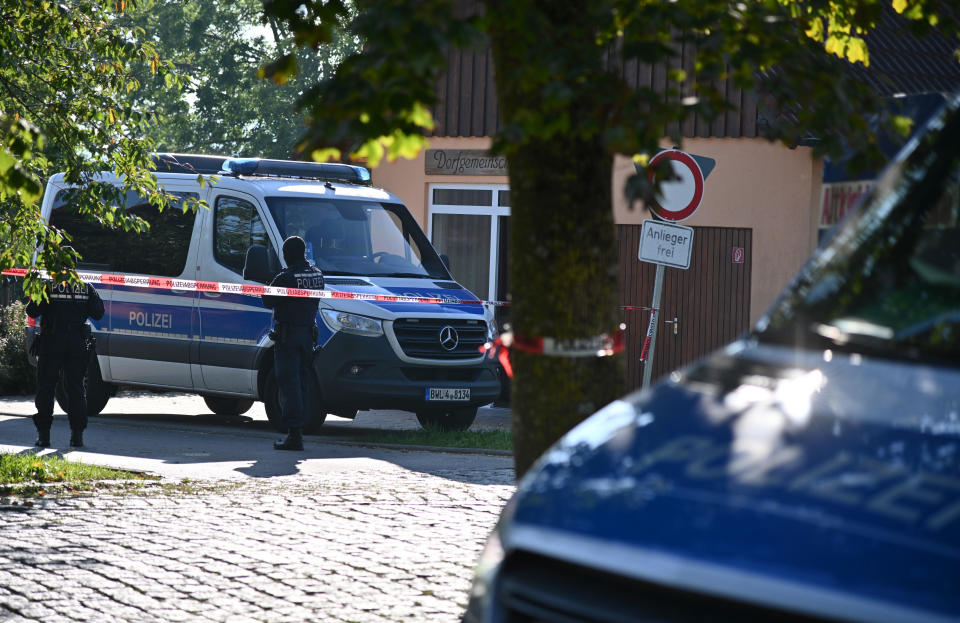 Police are seen during the search of a home belonging to a memb of the newly-banned neo-Nazi group 