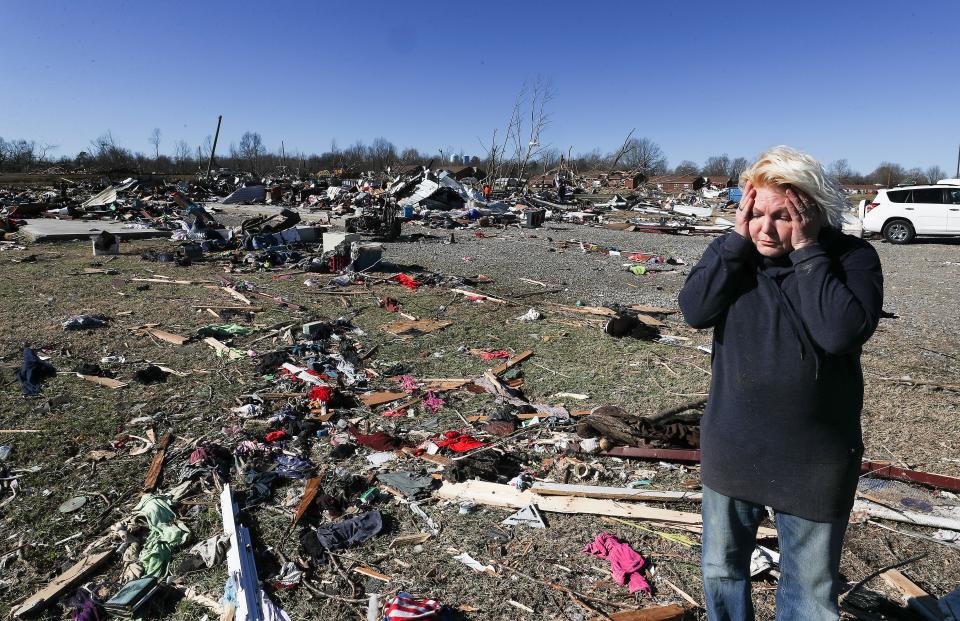 Stacy Bryan became emotional while salvaging her belongings from a storage unit in Dawson Springs, Ky. on Dec. 13, 2021.  She was finding that most of her possessions were damaged or blown away following a tornado that caused deaths and destruction in the community.  