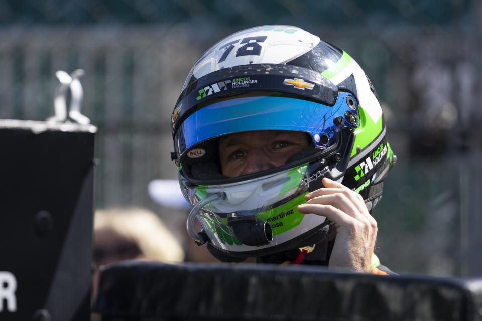 Agustin Canapino, of Argentina, takes off his helmet during a practice session for the IndyCar Grand Prix auto race at Indianapolis Motor Speedway, Friday, May 10, 2024, in Indianapolis. (AP Photo/Darron Cummings)